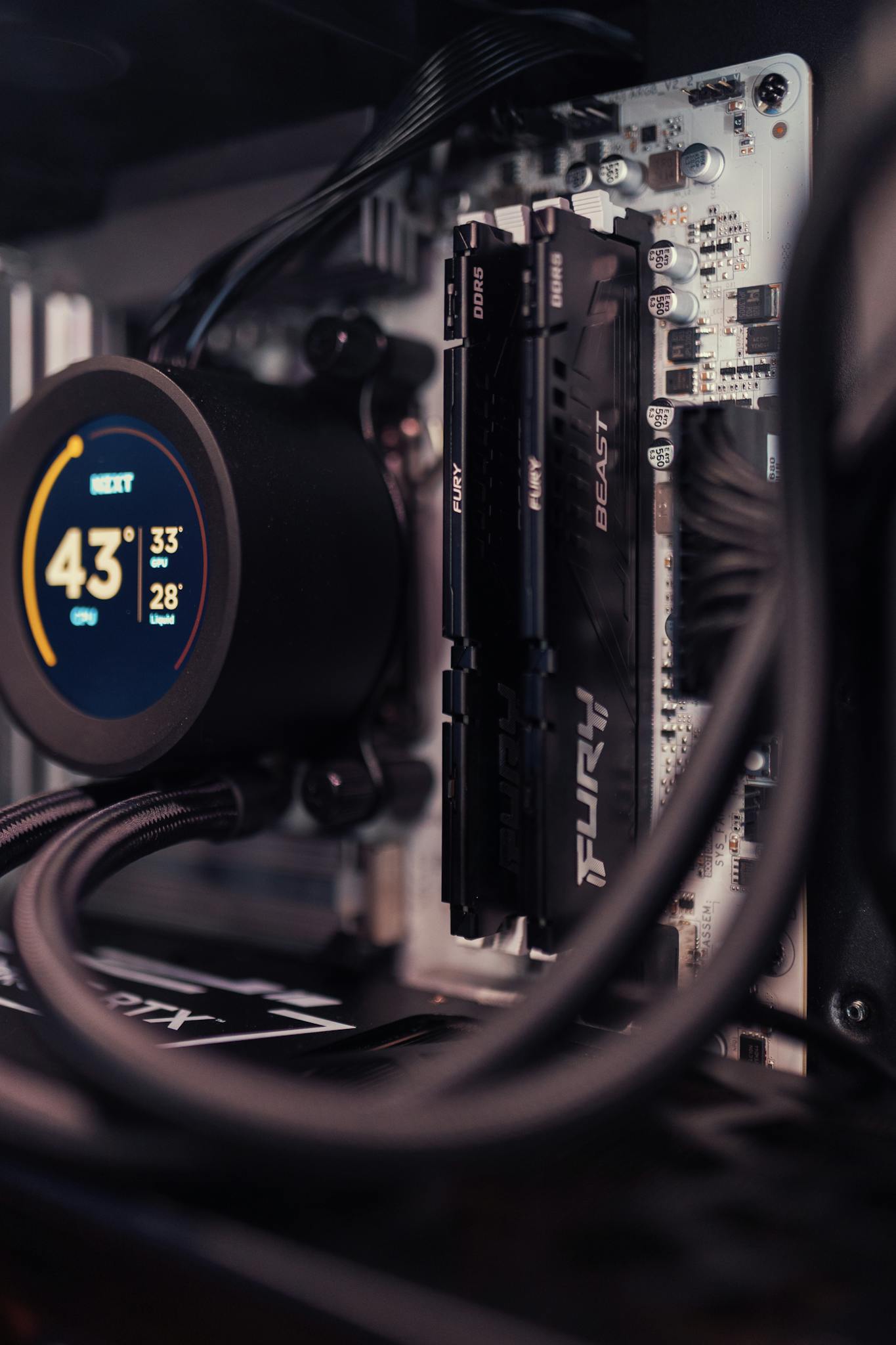 Detailed view of a gaming PC build featuring RAM and cooling system.